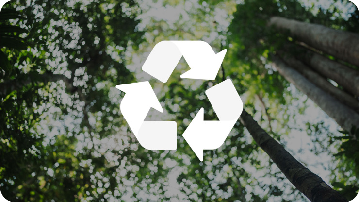 Recycling icon over a backdrop of trees